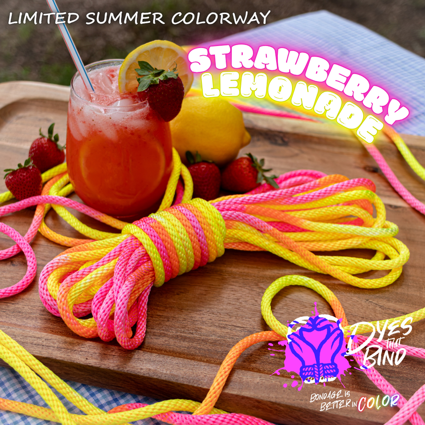 A bundle of bright neon-colored rope or cord wrapped in pink, yellow, orange, and blue stripes, styled on a wooden board with a drink, strawberries, lemons, and promotional text reading 'Strawberry Lemonade' and 'Dye the Band'.